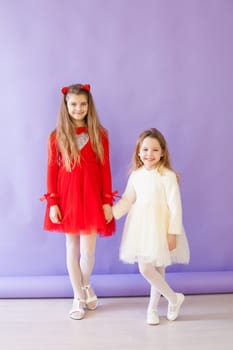 Two girls in red and white dresses