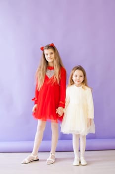 Two girls in red and white dresses