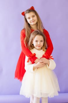 Two girls in red and white dresses