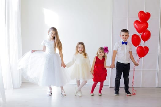 children with red heart balloons