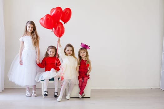 boy and girls with red balloons