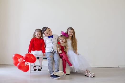 boy and girls with red balloons