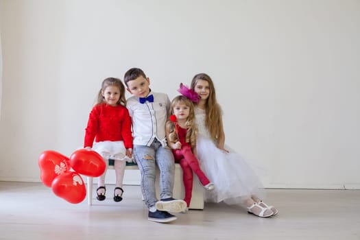 boy and girls with red balloons