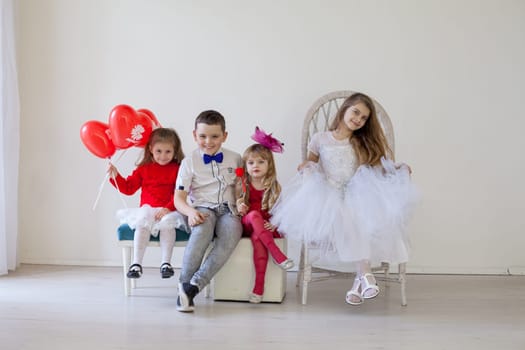 boy and girls with red balloons