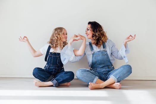 Mom and daughter show heart hands