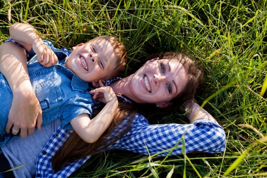 Mom and son play in the park on nature