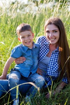 Mom and son play in the park on nature