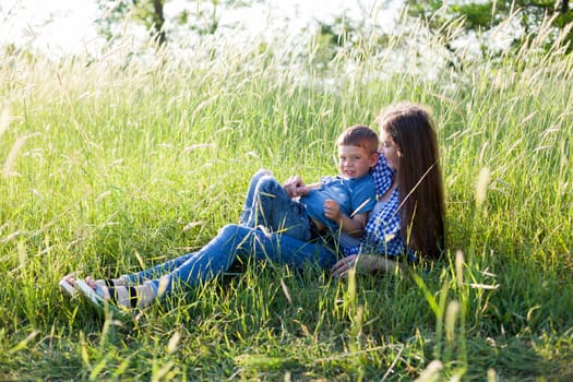 Mom and son play in the park on nature