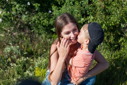 Mom and son play in the park on nature