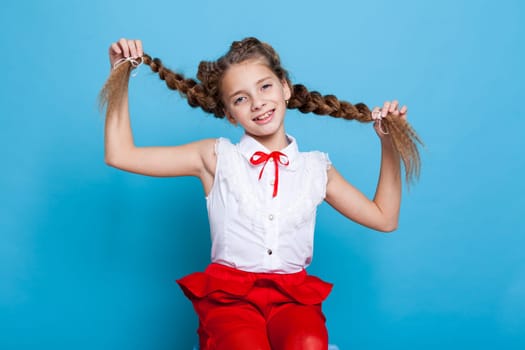 portrait of a beautiful schoolgirl with pigtails 11 years old