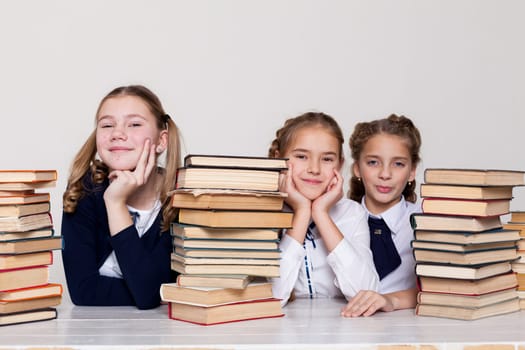 three schoolgirl at the desk study books