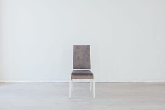 gray chair stands alone in the room