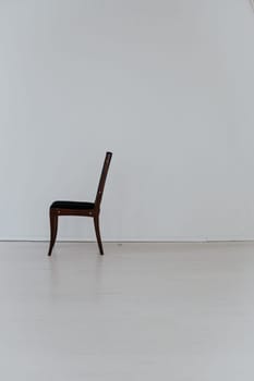 black chair stands alone in the room