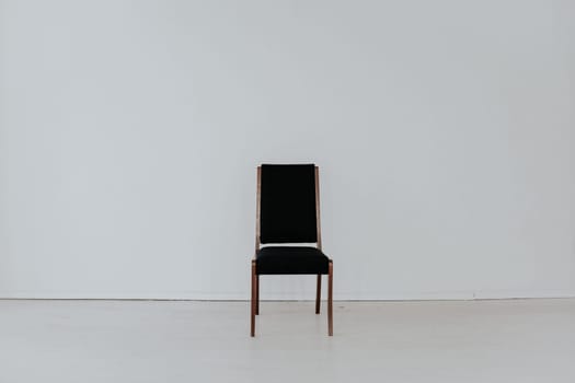 black chair stands alone in the room