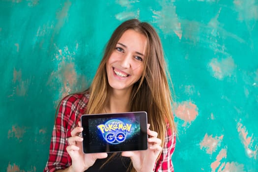 Ufa, Russia. - July 29: Woman show the tablet with Pokemon Go logo