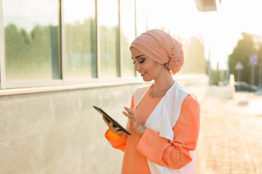 beautiful arabian girl with tablet computer. Muslim woman