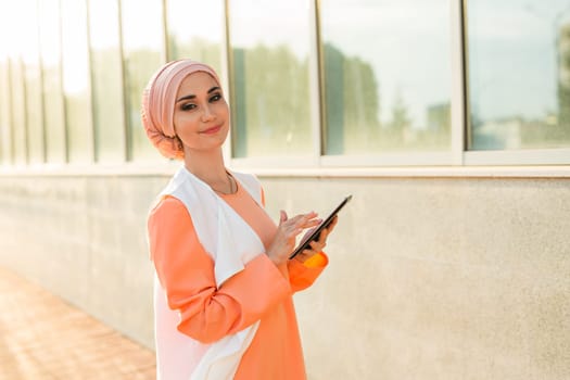 beautiful arabian girl with tablet computer. Muslim woman