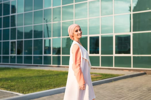 girl in abaya on the background of the business center.