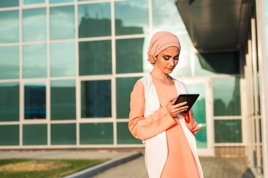 beautiful arabian girl with tablet computer. Muslim woman