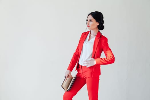 female student in red business suit with book in hand