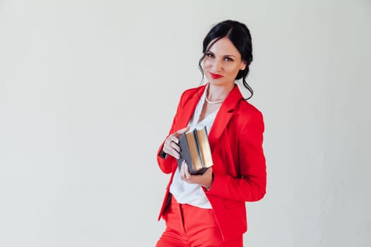 female student in red business suit with book in hand