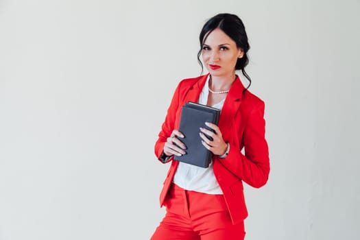 female student in red business suit with book in hand