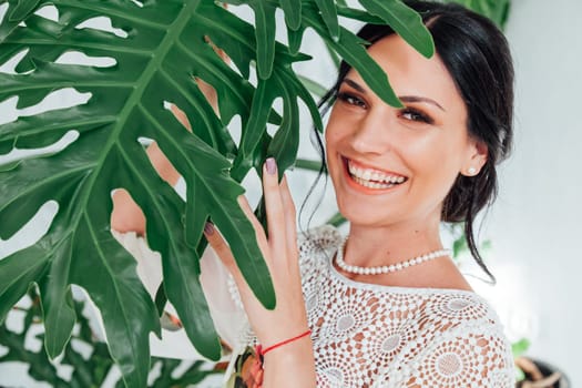 Portrait of a brunette woman in green plants