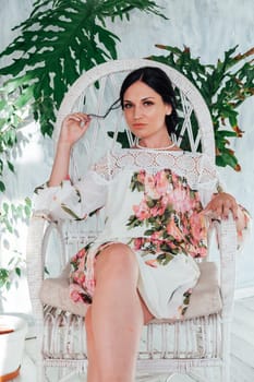 Portrait of a brunette woman in green plants