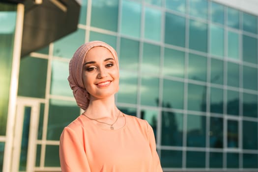 girl in abaya on the background of the business center.