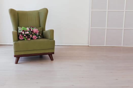 vintage chair with flowers in an empty white room