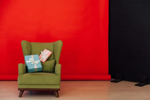 Red black background green chair with gifts for Christmas birthday party