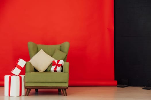 Red black background green chair with gifts for Christmas birthday party