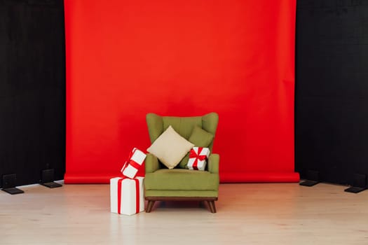 Red black background green chair with gifts for Christmas birthday party