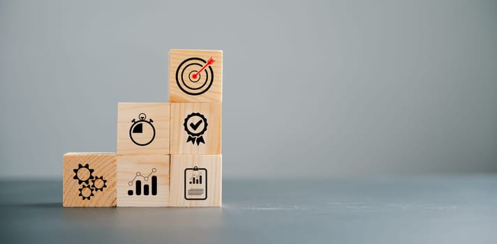 Action Plan, Goal, and Target icons on a wooden cube block step. Success and business target concept. Project management and company strategy symbolize achievement.