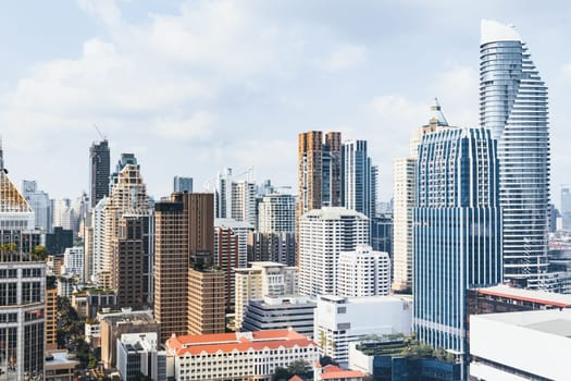 Closeup image of Bangkok cityscape. Modern cityscape surrounded with architectural building with day light and blue sky. Side view. Business background. Day light. Ornamented.