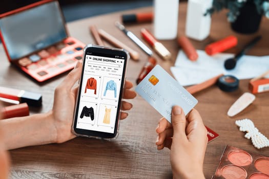 Woman shopping online on internet marketplace browsing for sale items for modern lifestyle and use credit card for online payment from wallet protected by utmost cyber security software