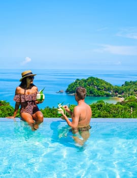 a young couple of men and women at a swimming pool during a vacation on a tropical island in Thailand