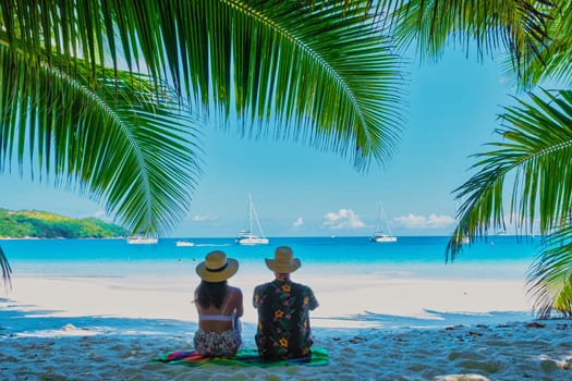 Anse Lazio Beach Praslin Seychelles, a young couple of men and women on a tropical beach during a luxury vacation in Seychelles.