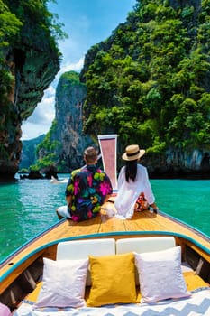 Luxury Longtail boat in Krabi Thailand, couple man, and woman on a boat trip to the tropical island, 4 Island trip in Krabi Thailand.