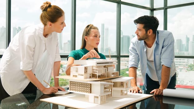 Smart architect team discussion about house design while handsome male worker present idea by using laptop. Group of professional engineer sharing, brainstorming design. Business design. Tracery