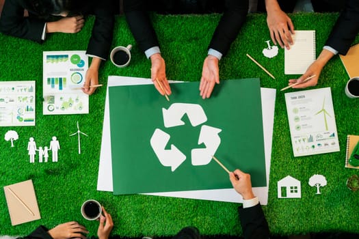 Top view panorama banner recycle icon on meeting table in office with business people planning eco business investment on waste management as recycle reduce reuse concept for clean ecosystem. Quaint