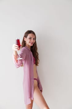 woman in lingerie with a glass of wine
