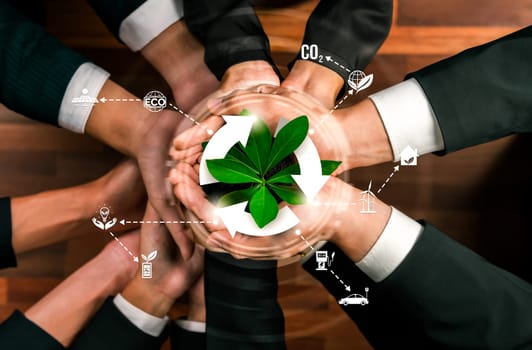 Business partnership holding plant together with recycle icon symbolize ESG sustainable environment nurturing and ecosystem protection with eco technology and waste recycling. Reliance