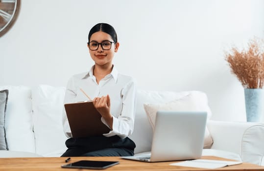 Psychologist woman in clinic office professional portrait with friendly smile feeling inviting for patient to visit the psychologist. The experienced and confident psychologist is uttermost specialist