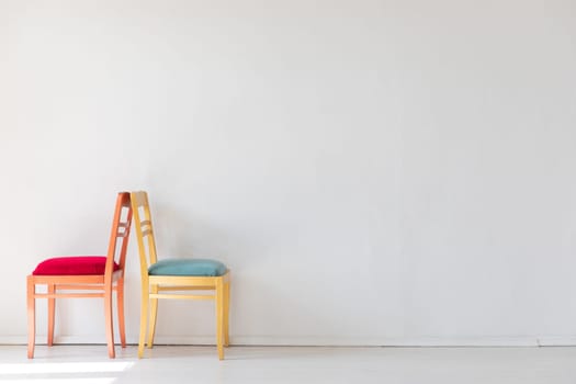 Two chairs in the interior of a white room