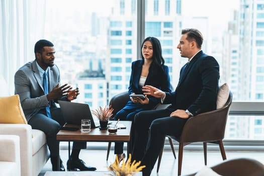 African businessman present start up project to expert investor. Group of multicultural business team solving problems, discussing business idea with skyscraper at modern business lounge. Ornamented