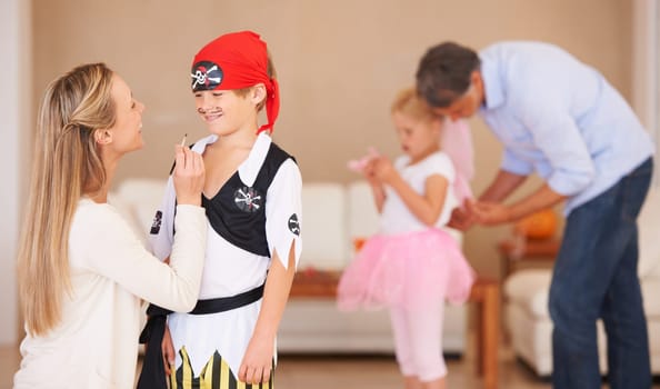 Boy, pirate costume and halloween with mother in home, face paint and happiness in childhood. Son, smile and house birthday with party clothes by woman, love family and celebration together with care.