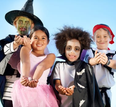 Children, group and portrait for halloween costume for sweet candy asking, trick or treat for fantasy. Friends, hands or dress up as witch or pirate for holiday fun or kid development, smile for play.