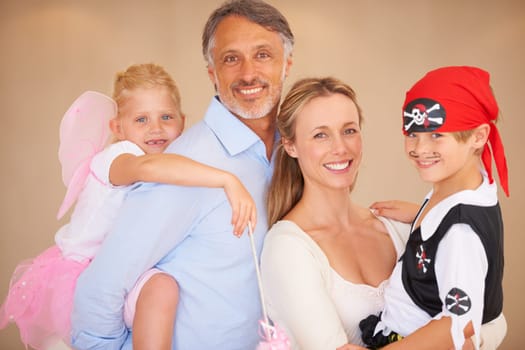 Happy family, portrait and halloween party in home, face paint and happiness in childhood. Man, woman and kids with house event clothes for birthday, love care and celebration together with wellness.