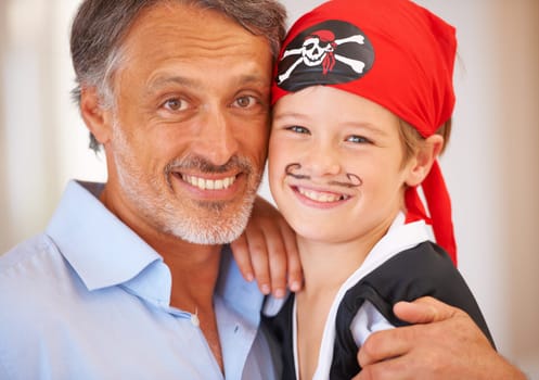 Family, portrait and father with son for halloween party, home and face paint for happiness in childhood. Man, child and holiday event, pirate costume and love for celebration together with wellness.